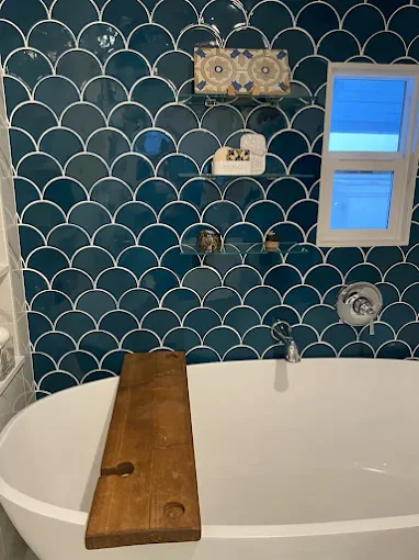 Bathroom remodel with a floral accent wall, updated vanity, and modern fixtures