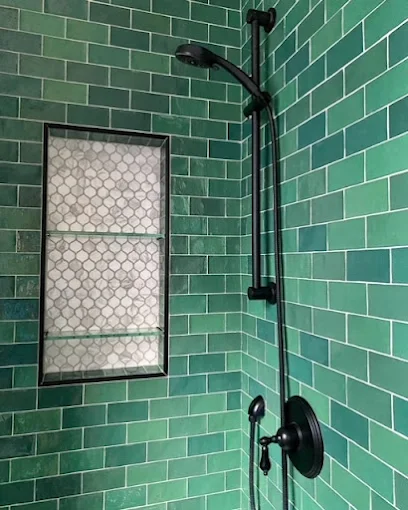 Green‑tiled bathroom remodel with matching green walls, floor, and modern fixtures