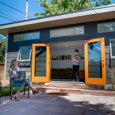 Modern detached accessory dwelling unit (DADU) with contemporary exterior and large windows in the backyard.